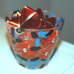 Painted plastic cup with red ribbon